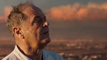 Movie still from “The Bucket List” (2007), directed by Rob Reiner – An older man looking up into the sky at sunset; Close Up shot, Low angle