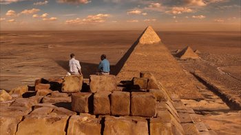 Movie still from “The Bucket List” (2007), directed by Rob Reiner – Two men sitting on top of a pile of rocks; Extreme Wide shot, High angle
