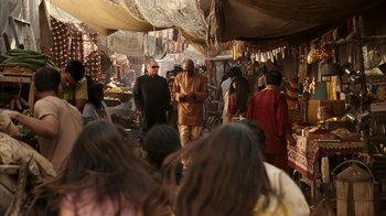 Movie still from “The Bucket List” (2007), directed by Rob Reiner – A group of people walking through a market area; Wide shot, Over the shoulder angle