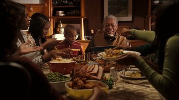 Movie still from “The Bucket List” (2007), directed by Rob Reiner – A group of people sitting around a table eating; Medium shot, High angle