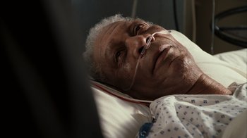 Movie still from “The Bucket List” (2007), directed by Rob Reiner – An older man laying in a hospital bed; Close Up shot, Overhead angle