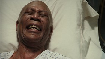 Movie still from “The Bucket List” (2007), directed by Rob Reiner – An older man laying in a hospital bed with his mouth open; Close Up shot, Overhead angle