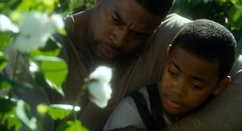 Movie still from “The Butler” (2013), directed by Lee Daniels – A man and a boy are looking at a flower; Close Up shot, Low angle