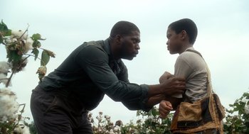 Movie still from “The Butler” (2013), directed by Lee Daniels – A man and a young boy are touching each other; Medium shot, Low angle