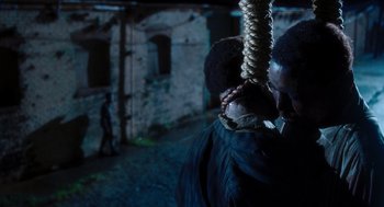 Movie still from “The Butler” (2013), directed by Lee Daniels – A man hanging from a rope in a dark alley; Close Up shot, Over the shoulder angle