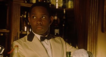 Movie still from “The Butler” (2013), directed by Lee Daniels – A man in a white jacket and bow tie holding a drink; Close Up shot, Low angle