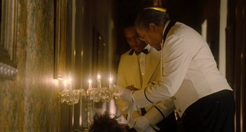 Movie still from “The Butler” (2013), directed by Lee Daniels – Two men standing in front of lit candles; Medium shot, Over the shoulder angle