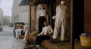 Movie still from “The Butler” (2013), directed by Lee Daniels – A group of men standing next to each other on a porch; Wide shot, Low angle