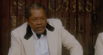 Movie still from “The Butler” (2013), directed by Lee Daniels – An older man in a white suit with a black bow tie; Close Up shot, Low angle