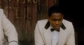 Movie still from “The Butler” (2013), directed by Lee Daniels – A man wearing a white suit and bow tie; Close Up shot, High angle