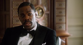 Movie still from “The Butler” (2013), directed by Lee Daniels – A man in a tuxedo sitting in front of a wooden wall; Close Up shot, Over the shoulder angle