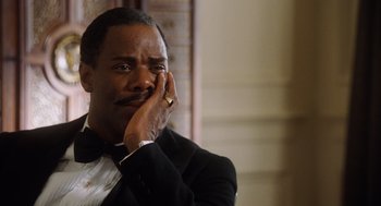 Movie still from “The Butler” (2013), directed by Lee Daniels – A man in a tuxedo is holding his hand up to his face; Close Up shot, Low angle