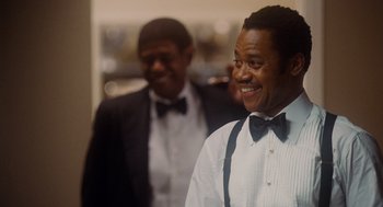 Movie still from “The Butler” (2013), directed by Lee Daniels – A man in a white shirt and bow tie standing next to another man in a black suit; Close Up shot, Over the shoulder angle