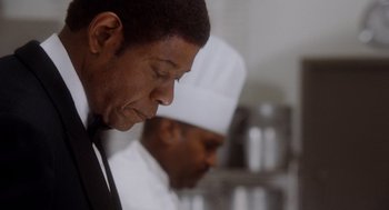 Movie still from “The Butler” (2013), directed by Lee Daniels – A man in a chef's hat looking down at his face; Close Up shot, Low angle