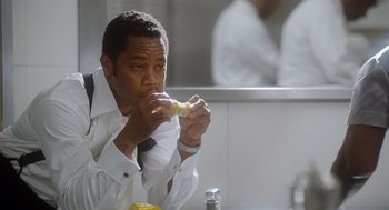 Movie still from “The Butler” (2013), directed by Lee Daniels – A man sitting in front of a mirror eating a sandwich; Close Up shot, Low angle