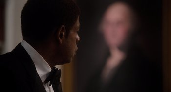 Movie still from “The Butler” (2013), directed by Lee Daniels – A person wearing a suit and tie; Close Up shot, Over the shoulder angle