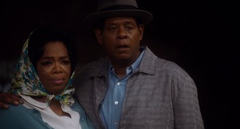 Movie still from “The Butler” (2013), directed by Lee Daniels – A man and a woman standing next to each other in front of a wall; Close Up shot, Low angle