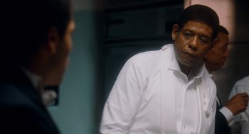 Movie still from “The Butler” (2013), directed by Lee Daniels – A man wearing a white shirt is looking at himself in the mirror; Close Up shot, Over the shoulder angle