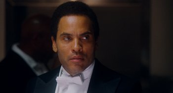 Movie still from “The Butler” (2013), directed by Lee Daniels – A person wearing a suit and tie; Close Up shot, Low angle