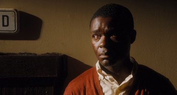Movie still from “The Butler” (2013), directed by Lee Daniels – A black man wearing a red and white sweater; Close Up shot, High angle