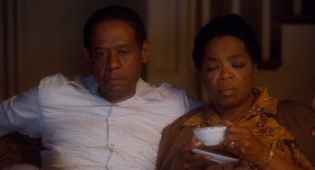 Movie still from “The Butler” (2013), directed by Lee Daniels – A man and a woman sitting next to each other; Medium shot, High angle