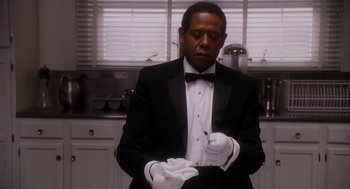 Movie still from “The Butler” (2013), directed by Lee Daniels – A man in a black tuxedo and white gloves; Medium shot, Low angle