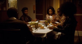 Movie still from “The Butler” (2013), directed by Lee Daniels – A group of people sitting around a table eating food; Medium shot, High angle
