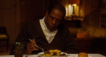 Movie still from “The Butler” (2013), directed by Lee Daniels – A man sitting at a table eating food; Close Up shot, High angle