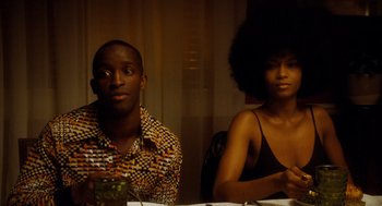 Movie still from “The Butler” (2013), directed by Lee Daniels – A man and a woman sitting at a dinner table; Medium shot, Low angle