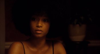Movie still from “The Butler” (2013), directed by Lee Daniels – A young woman is sitting in a dark room; Close Up shot, Over the shoulder angle