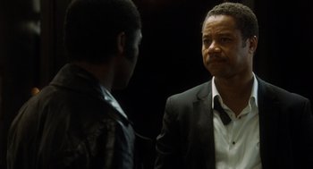 Movie still from “The Butler” (2013), directed by Lee Daniels – Two men in suits talking to each other in a dark room; Close Up shot, Over the shoulder angle