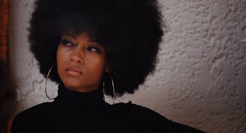 Movie still from “The Butler” (2013), directed by Lee Daniels – A person with a large afro; Close Up shot, Over the shoulder angle