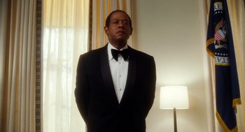 Movie still from “The Butler” (2013), directed by Lee Daniels – A man in a tuxedo standing in front of a lamp; Medium shot, Low angle