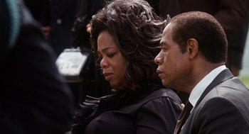 Movie still from “The Butler” (2013), directed by Lee Daniels – A woman and a man in a black suit; Close Up shot, Over the shoulder angle