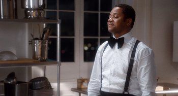 Movie still from “The Butler” (2013), directed by Lee Daniels – A man in a white shirt and black bow tie; Medium shot, Over the shoulder angle