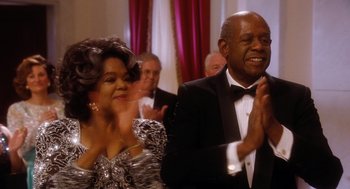 Movie still from “The Butler” (2013), directed by Lee Daniels – A man and a woman are clapping at a formal event; Medium shot, Low angle
