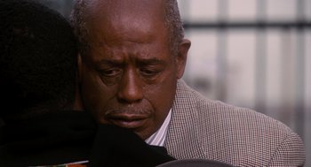 Movie still from “The Butler” (2013), directed by Lee Daniels – An older man in a suit is looking down; Close Up shot, Over the shoulder angle