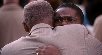 Movie still from “The Butler” (2013), directed by Lee Daniels – Two people hugging each other in a crowd; Close Up shot, Over the shoulder angle