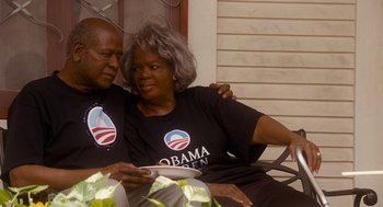 Movie still from “The Butler” (2013), directed by Lee Daniels – An older man and woman sitting next to each other on a porch; Medium shot, High angle