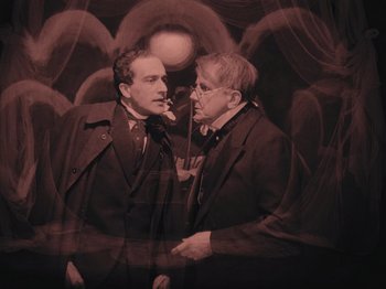 Movie still from “The Cabinet of Dr. Caligari” (1920), directed by Robert Wiene – A couple of men standing next to each other; Medium shot, Low angle