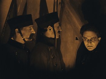 Movie still from “The Cabinet of Dr. Caligari” (1920), directed by Robert Wiene – A group of men standing next to each other; Medium shot, Low angle