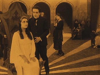 Movie still from “The Cabinet of Dr. Caligari” (1920), directed by Robert Wiene – A group of people standing in a room; Wide shot, High angle