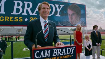 Movie still from “The Campaign” (2012), directed by Jay Roach – A man in a suit and tie standing at a podium; Medium shot, Low angle