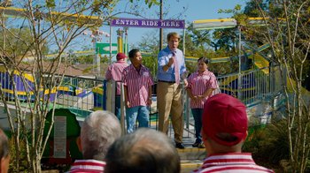 Movie still from “The Campaign” (2012), directed by Jay Roach – A group of people standing on top of a platform; Wide shot, Over the shoulder angle