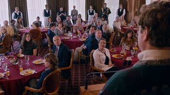 Movie still from “The Campaign” (2012), directed by Jay Roach – A group of people sitting at tables in a room; Wide shot, Over the shoulder angle