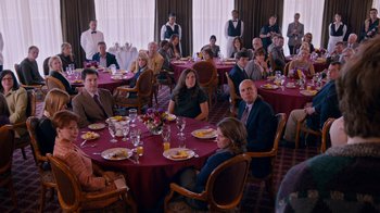 Movie still from “The Campaign” (2012), directed by Jay Roach – A group of people sitting at a table with plates of food on it; Wide shot, High angle