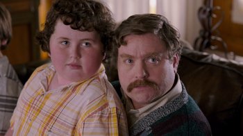 Movie still from “The Campaign” (2012), directed by Jay Roach – A man and a boy pose for a picture; Close Up shot, Over the shoulder angle