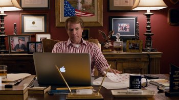 Movie still from “The Campaign” (2012), directed by Jay Roach – A man sitting in front of an open laptop computer; Medium shot, High angle