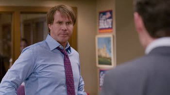 Movie still from “The Campaign” (2012), directed by Jay Roach – A man wearing a blue dress shirt and a red tie; Medium shot, Over the shoulder angle