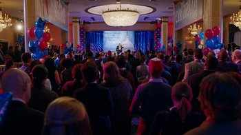 Movie still from “The Campaign” (2012), directed by Jay Roach – A crowd of people in front of a stage; Extreme Wide shot, High angle